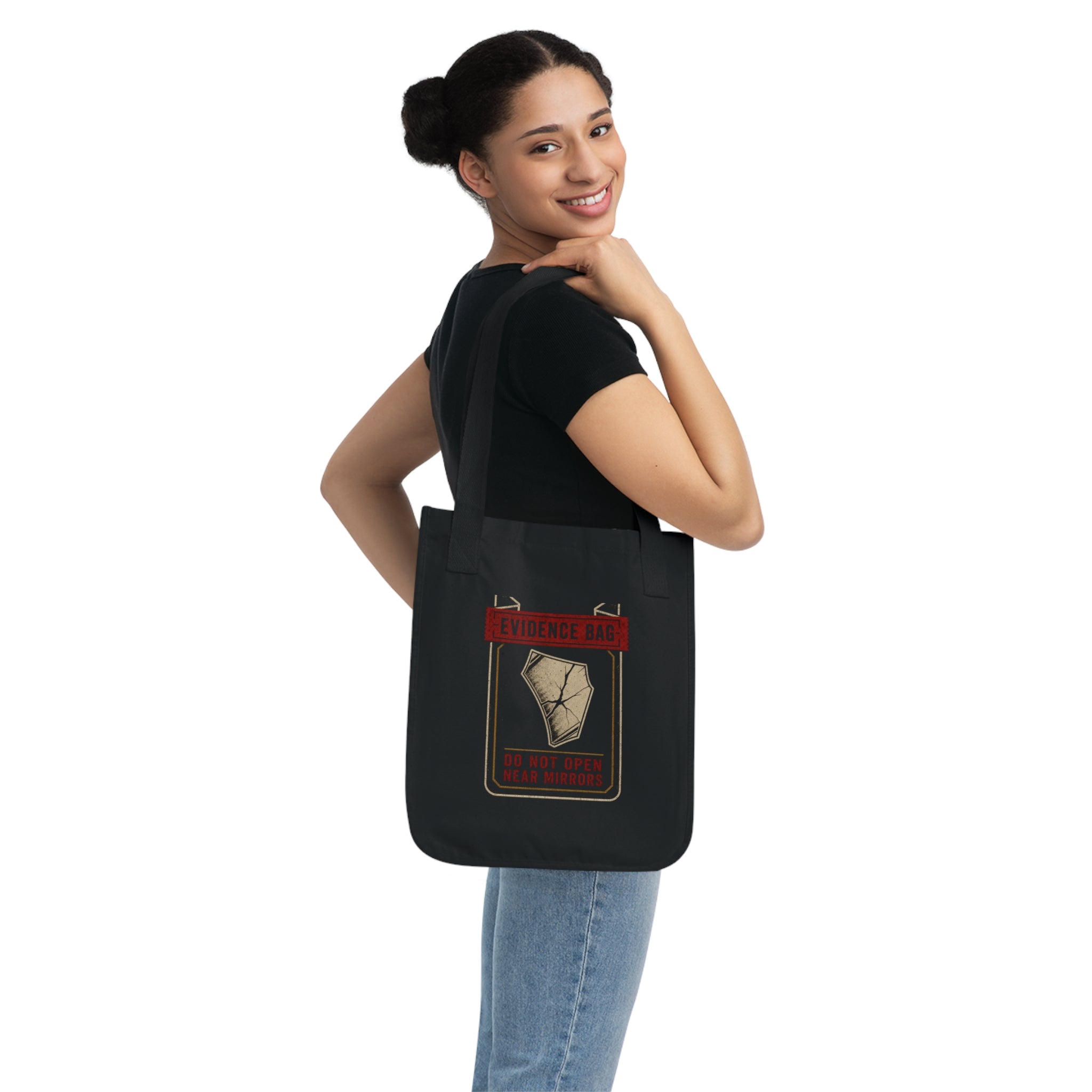 Black organic cotton Evidence Division tote shown on shoulder